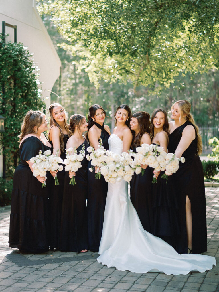 bridal party photos with black bridesmaid dresses and white florals