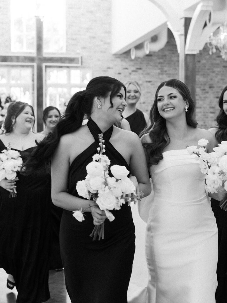 bridal party photos with black bridesmaid dresses and white florals